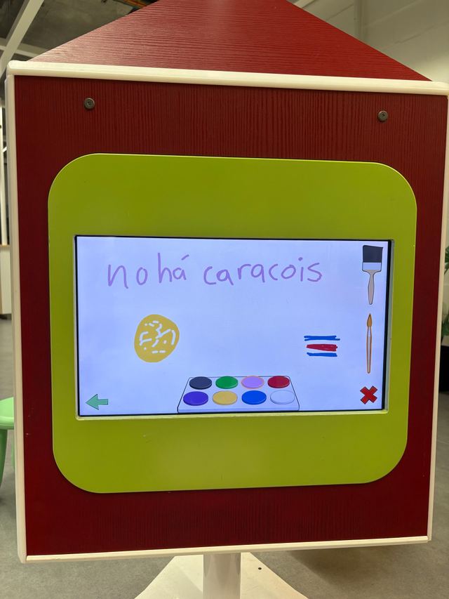 “no há caracois” written in purple on a toy drawing screen in a children's play kitchen